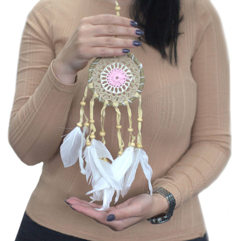 Pastel pink macramé dream catcher 9cm held in hand for size reference