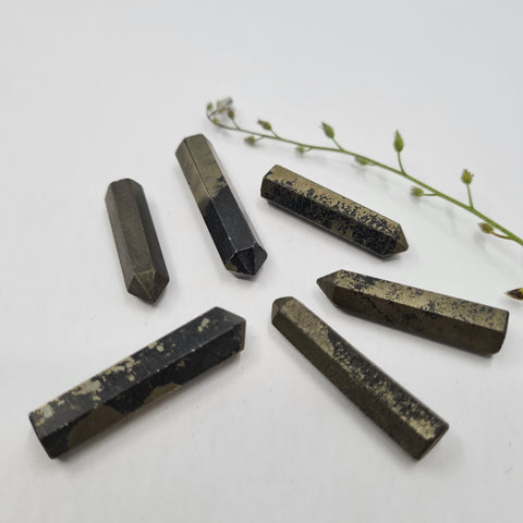 Pyrite crystal point with metallic gold tones symbolising luck, protection, and abundance. Associated with the Solar Plexus and Base Chakras and the astrological sign Leo.