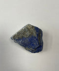 Raw lapis lazuli piece showing deep blue with gold pyrite flecks on white background — Fragrant Heaven