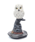 Resin owl statue perched on a black witch hat, symbolizing intuition, hidden knowledge, and spiritual protection. Used for Wicca decoration, altars, and mystical décor.