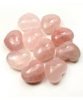 Selection of rose quartz polished puff hearts showing natural variation in soft pink colour on white background — Fragrant Heaven