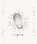 Selenite meaning card front showing white translucent tumbled stone on cream mystical bordered card — Fragrant Heaven