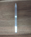 Slender selenite pointed wand on wooden background showing tapered tip and silky white surface — Fragrant Heaven