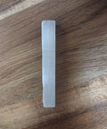 Raw selenite wand 10cm rectangular bar shape on wooden background — Fragrant Heaven