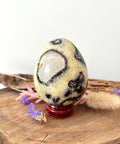 Septarian crystal egg with yellow calcite and dark natural patterns for grounding and strength