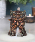 Small Green Man Backflow Incense Burner in use with incense cone lit and smoke effect flowing.
