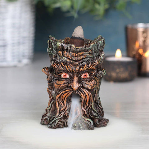 Small Green Man Backflow Incense Burner in use with incense cone lit and smoke effect flowing.