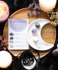 Stress Healing Crystal Set with Moon Trinket Dish displayed on wooden tray with candles and flowers