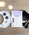 Healing Crystal Set with moon trinket dish, crystal card and drawstring pouch on wooden surface