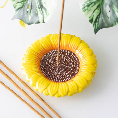Sunflower ceramic incense holder plate on table