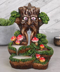 Tree Man Backflow Incense Burner with smoke cascading downwards.