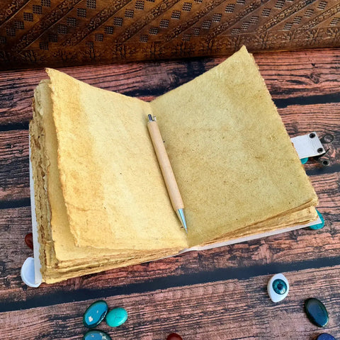 Tree of life leather journal open showing vintage handmade pages with deckle edge paper