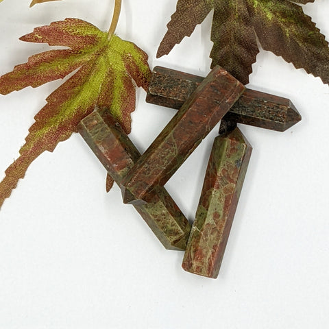 Unakite crystal point with green and pink tones symbolising healing, balance, and grounding. Associated with the Heart Chakra and the astrological sign Scorpio.
