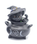 Statue featuring black cat with black witch hat sitting in cauldron decorated with pentagram and triple moon symbols. Represents protection, transformation, and feminine energy in Wicca.