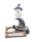 Resin owl candle holder with black witch’s hat and book base, symbolizing wisdom, intuition, and spiritual connection in Wicca. Holds a tealight candle.