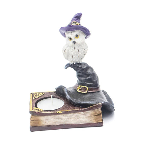 Resin owl candle holder with black witch’s hat and book base, symbolizing wisdom, intuition, and spiritual connection in Wicca. Holds a tealight candle.