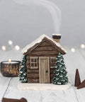 Winter Log Cabin Incense Cone Burner with smoke rising from the chimney.